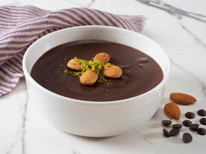 Un bowl que contiene budin de chocolate con decoración de almendras