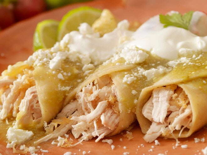 Burrito de Pollo con Salsa de Aguacate y Verduras Tres burritos de pollo con salsa en un plato marrón